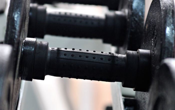 Close-up view of black dumbbells racked in a gym