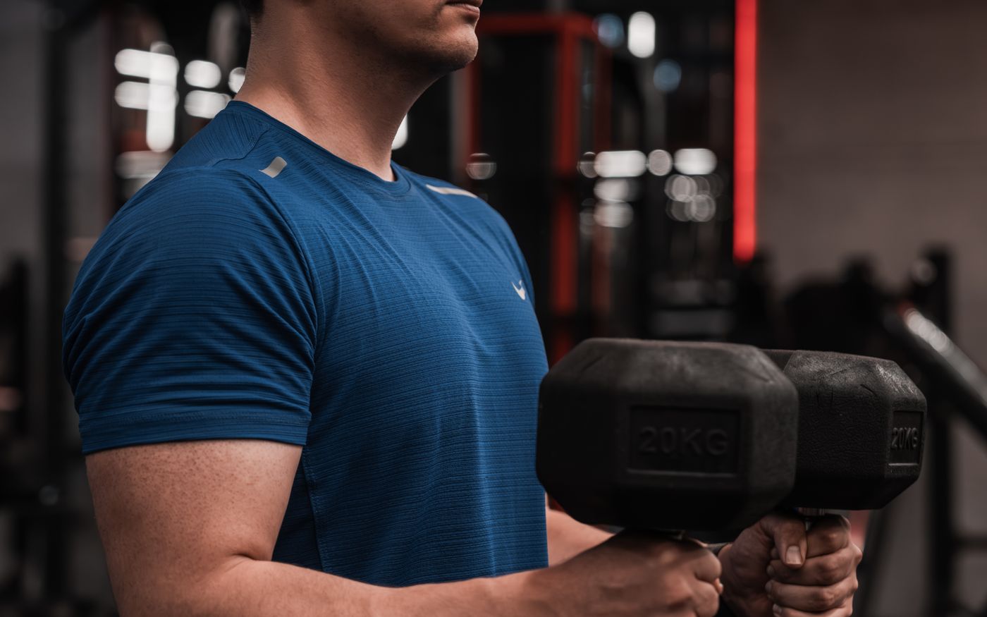 A person lifting dumbbells in a gym